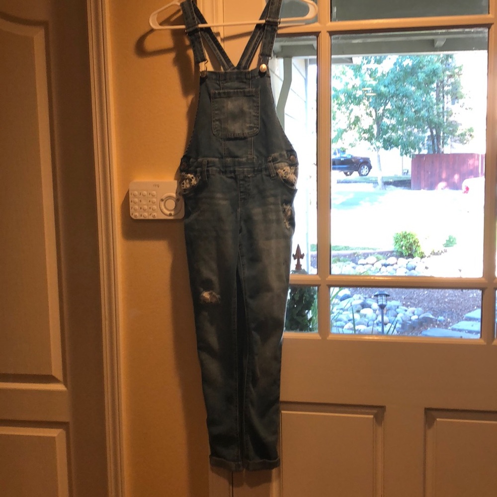A pair of overalls with floral stitching!